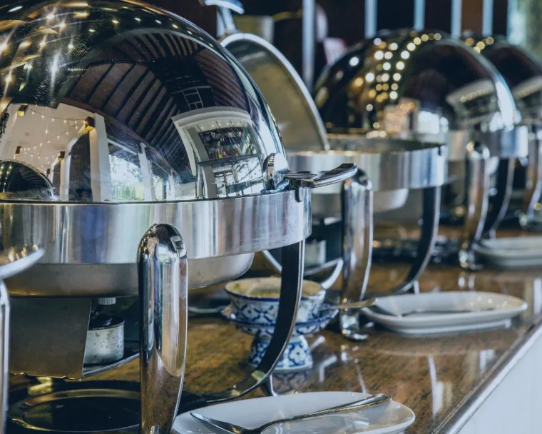 A buffet setup with various dishes, representing the food service industry